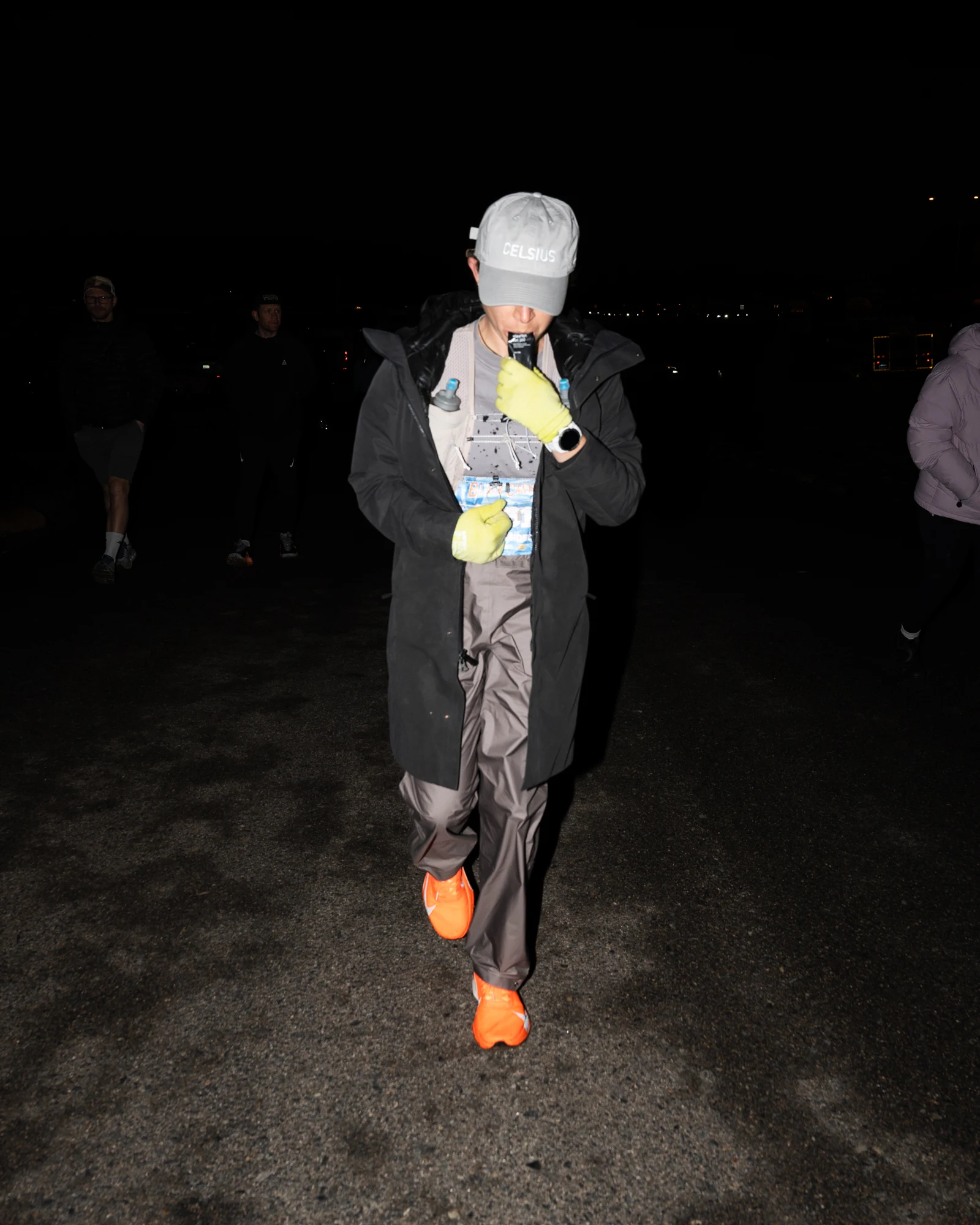 Molly Seidel carries race nutrition during a nighttime aid stop.