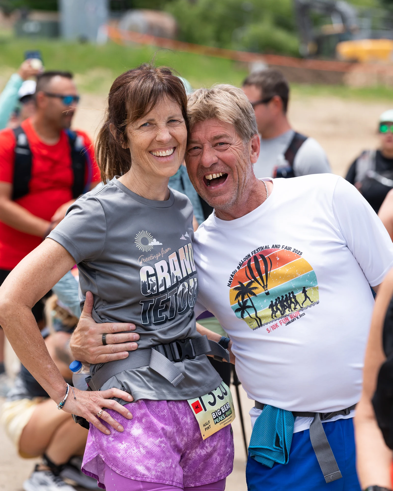 Two smiling runners pose together after a TransRockies stage.