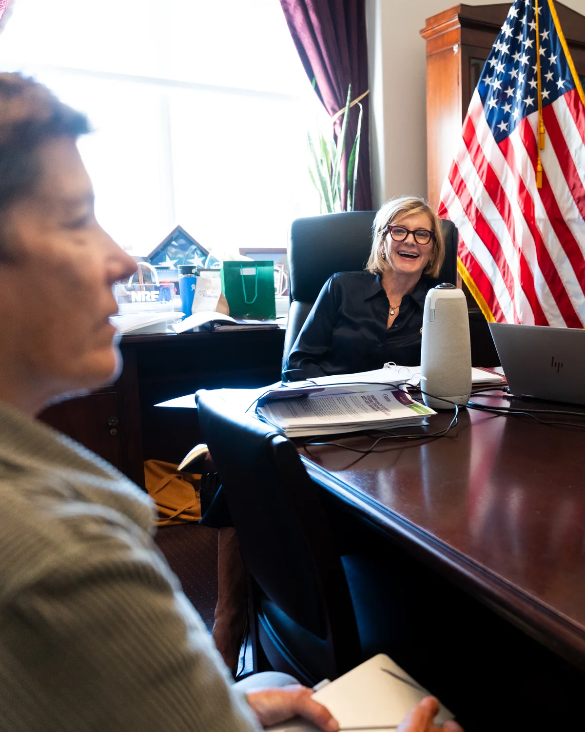 An advocate joins a conversation across an office desk.