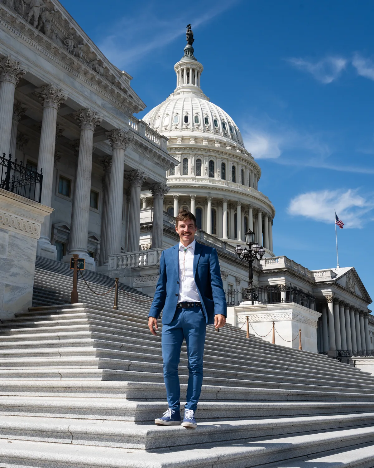An advocate stands on the steps outside the United States Capitol.