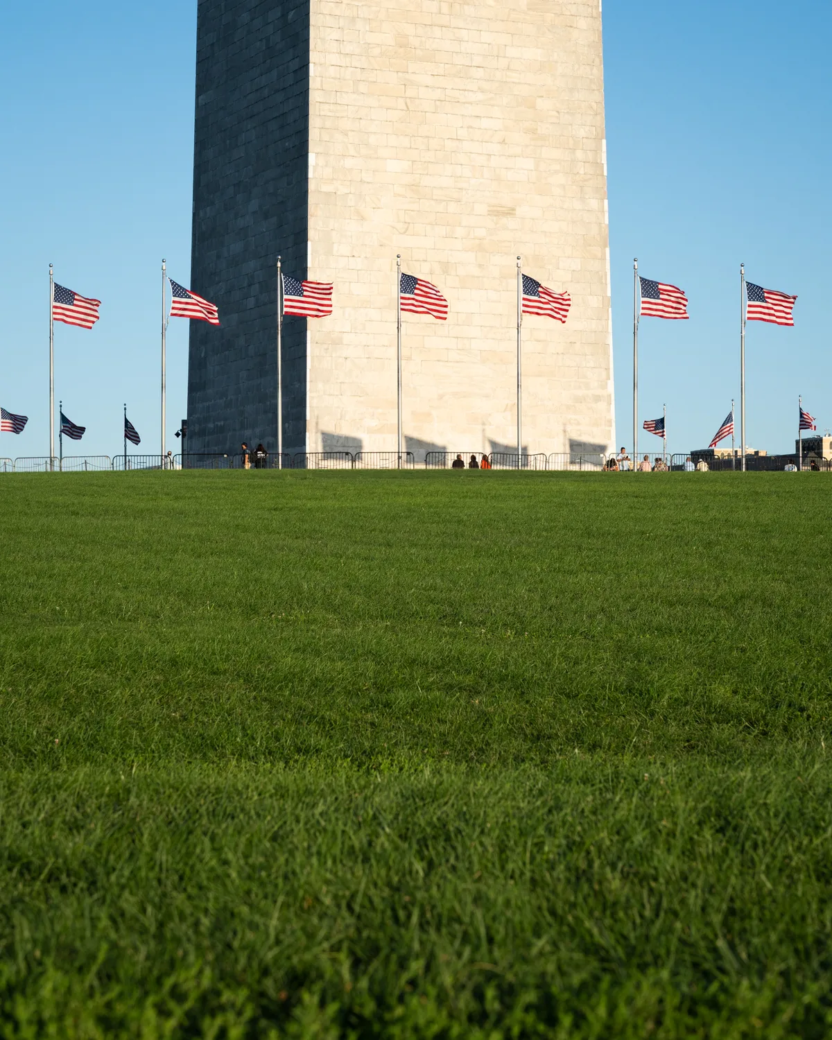 United States flags surround the base of the Washington Monument.