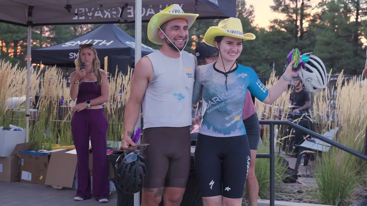 Preview image for Village Gravel Recap, showing two people in yellow hats at the race venue.